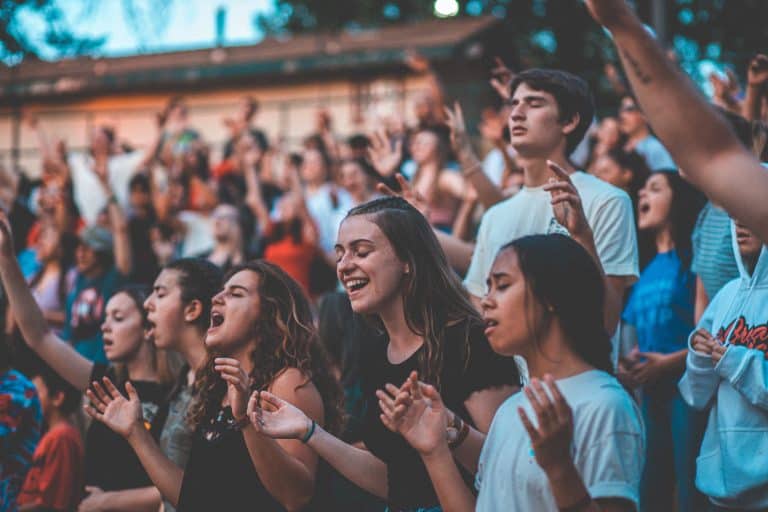 A line of young pilgrims singing together.